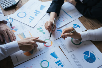 Close-up of business people group meeting and using check chart in office, brainstorming and...