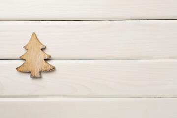Wooden Christmas tree on wooden background, top view