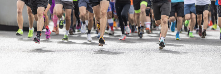 Runners in shorts and trainers start running a competition, with only their legs visible