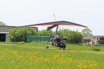 Obraz na płótnie Canvas Ultralight airplane taxiing on a farm strip 