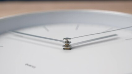 Close up time-lapse metal hands of white clock go forward. wall clock quickly shows time. Indistinguishable time, focus on center of hands.