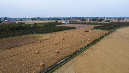 agrimotor moving sheaves in autumn in rural field © august.columbo