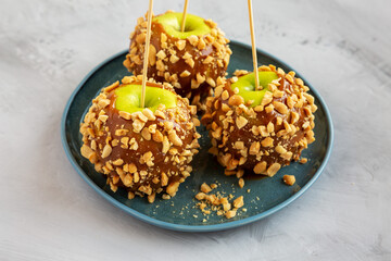 Homemade Halloween Candy Taffy Apples on a Plate, side view.