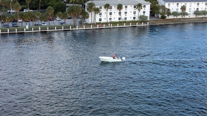Boat riding on the ocean with beach houses near by