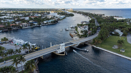 Air shot of bridge with boat going under the bridge.