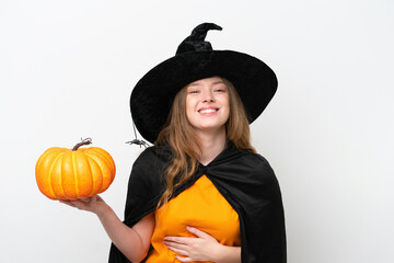 Young pretty woman costume as witch holding a pumpkin isolated on white background smiling a lot