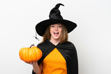 Young pretty woman costume as witch holding a pumpkin isolated on white background with surprise facial expression