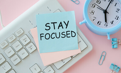 Stay Focused sticky note pasted on the keyboard