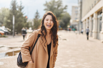 Lifestyle portrait of beautiful pretty asian kazakh woman laughing with a big, beautiful smile