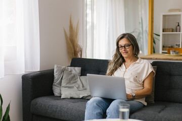 Adult woman working from home using laptop