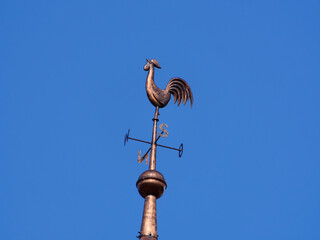 A weather vane on a church tower, here a catholic church.