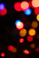 Abstract background with colorful sparkling bokeh on a dark background. Holiday concept