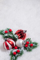 Naklejka na ściany i meble Red and White Christmas balls on snow.