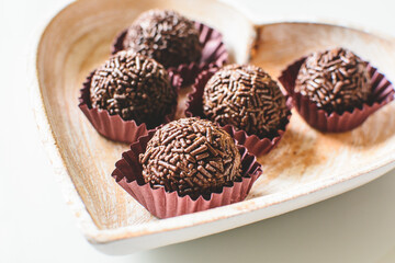 Brigadeiros, traditional Brazilian sweet, birthday party candy, on a hearth shaped plate