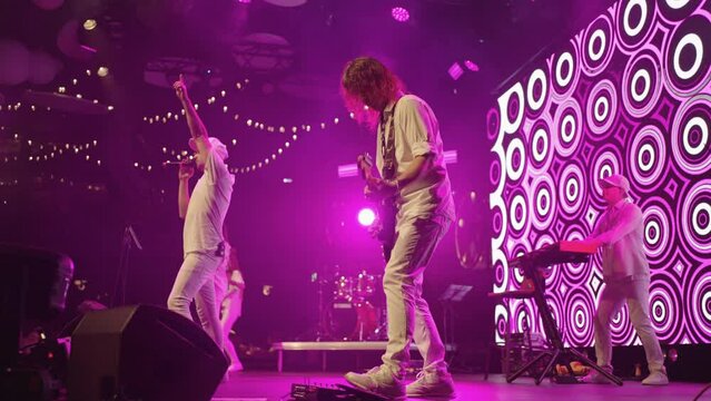 live music concert of popular rock, pop or jazz-funk band, musicians and singers on stage