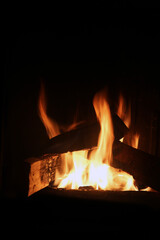 Bonfire burning and bringing in some heat, light and lovely atmosphere. Enjoy the fire in fireplace, as a campfire or simply as a background image. Closeup of abstract red, orange and yellow flames.