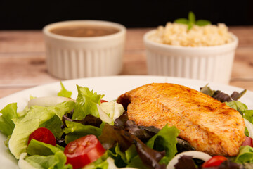 Healthy salad with chicken on a plate, lettuce, and organic vegetables