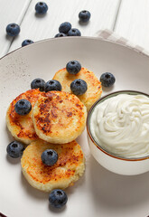 Cottage cheese pancakes , with blueberries ,breakfast , on a white wooden table, no people, top view,