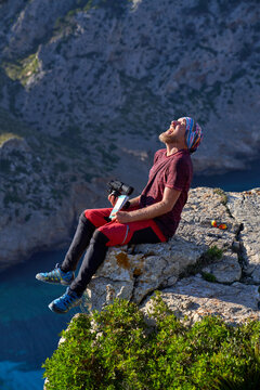 Carefree Traveler Laughing On Rocky Cliff