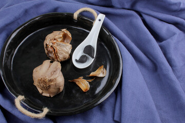 Black garlic made by fermenting process. Fermented foods. Healthy food concept.