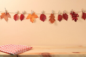 Empty kitchen wooden table for product display and maple leaves, minimal autumn concept, creative...