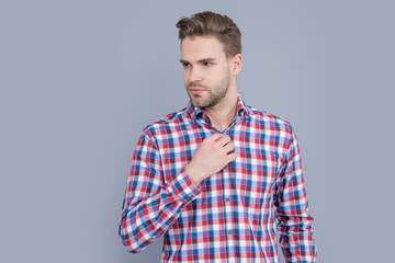 young man having stubble. handsome man in checkered shirt isolated on grey background.