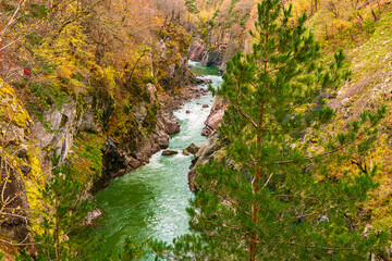 A deep mountain gorge with a river flowing through its bottom