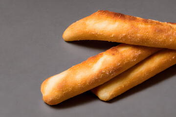 a photo of breadsticks, crusty baked food item, high calorie snack