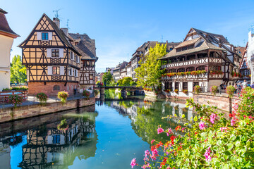 Picturesque half timbered buildings and the Maison des Tanneurs (tanners house) in the Petite France canal zone along the Ill river in the historic city of Strasbourg, in the Alsace region of France.  - obrazy, fototapety, plakaty