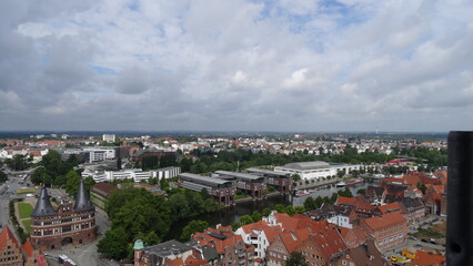 Lübeck, sky, clouds, buildings, trees and the holstentor at germany