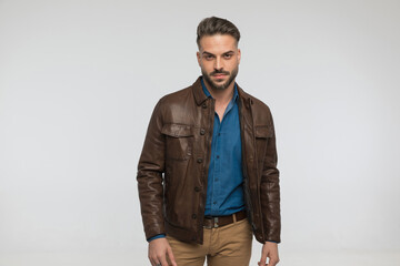 cool bearded man in casual outfit being confident and posing