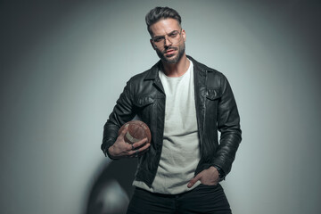 Obraz premium model holding a rugby ball and one hand in pocket