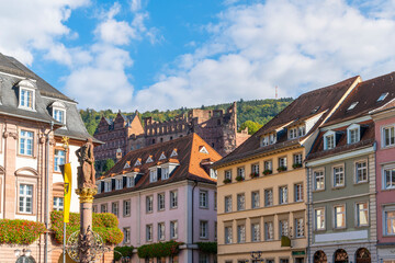 Fototapeta na wymiar The medieval Heidelberg Castle is seen above the colorful buildings at Marktplatz, or Market Square in the medieval old town of Heidelberg, Germany.