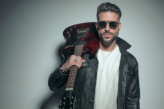 rocker wearing a black leather jacket and sunglasses