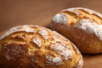 a loaf of bread, high calorie staple food, well baked and crusty