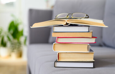 Stack of books with glasses in the room. Concept of knowledge and learning. Selective focus on books
