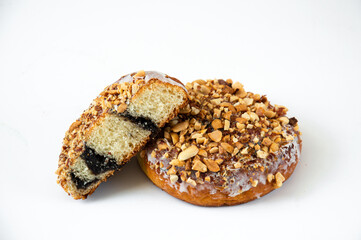 Yeast dough bun with poppy seeds with sprinkles on a white background