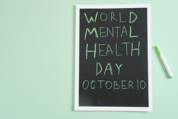 world mental health day, october 10, inscription on table green background