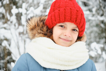 close up winter outdoor portrait of adorable teen girl in knitted hat and white scarf