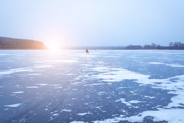 Beautiful winter evening landscape overlooking a river covered with ice and strewn with snow, winter background