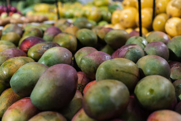 Fresh mangoes in the supermarket. Vegetables and fruits exposed for the consumer to choose