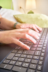 Vertical closeup of the hands on the keyboard.