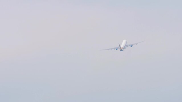 Footage unrecognizable jet plane flies away, gaining altitude, rear view long shot. Tourism and travel concept