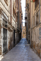 Fototapeta na wymiar Palermo, Sicily, Italy - July 6, 2020: Typical Italian street and buildings in the old town of Palermo, Sicily, Italy.