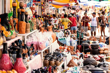 People and artisan pieces of ceramics on display at the Caxixis fair.