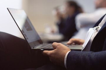 Business people hands using laptop computer during conference