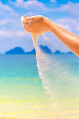 Sand falling through woman hands
