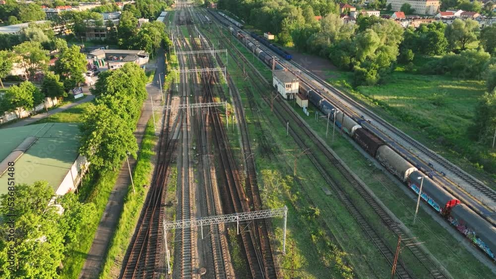 Poster the view from the drone on the railroad tracks against the background of the setting sun. concept of