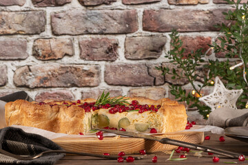 Homemade quiche with vegetables, brussels spouts, goat cheese and pomegranate. Vegetarian food. French cuisine