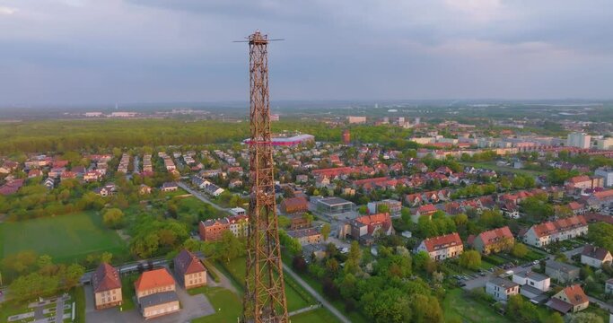 Aerial view of the wooden broadcasting tower in Gliwice with the city of Gliwice in the background. The concept of the largest wooden tower in the world. Wooden construction from a drone.